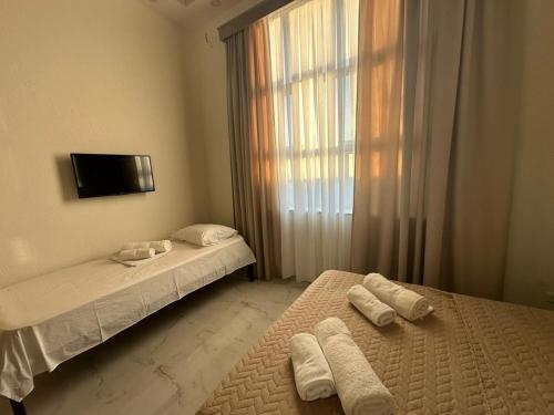 two beds in a room with towels on them at villacaptaingomi in Gomi