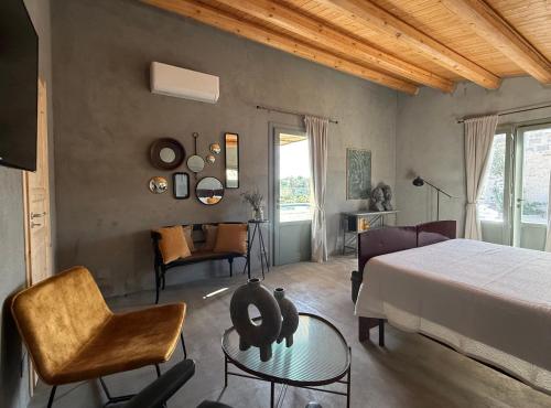 a bedroom with a bed and a table and chairs at Papalei La Maison in Ragusa