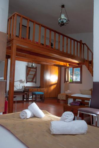 a living room with a loft bed with two towels at Villa Medusa in Hersonissos