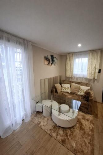 a living room with a couch and a table at Wilczy Domek nad Witką in Wilka