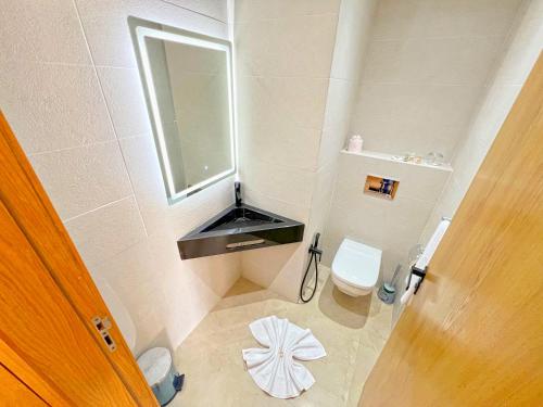 a small bathroom with a toilet and a mirror at Great Holiday suites in Agadir