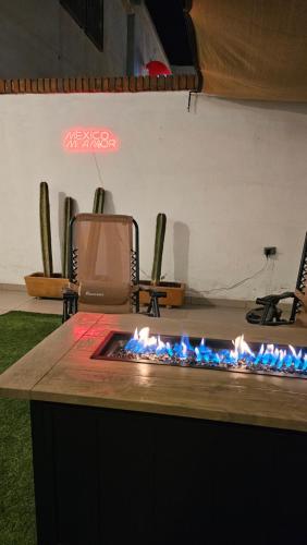 a counter with a blue fire in a room at Terraza y Fire pit con vista increíble in Chihuahua