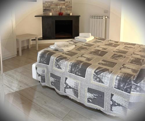 a bedroom with a bed with a blanket and a fireplace at Marselo B&B in Bari