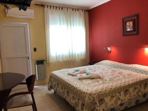 a bedroom with a bed with two towels on it at Calafquén in San Antonio Este