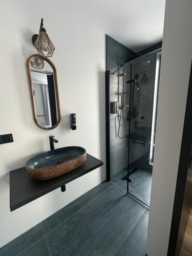 a bathroom with a sink and a shower at Radawa LOVE in Radawa