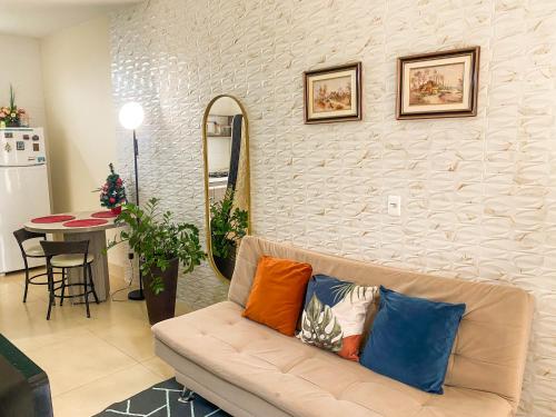 a living room with a couch with pillows on it at Flat Morada da Neblina! in Chapada dos Guimarães
