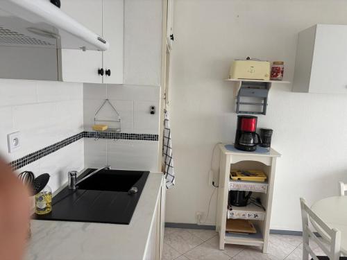 a kitchen with a sink and a counter top at Résidence MAYA in Saint-Lary-Soulan