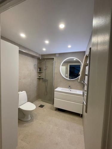a bathroom with a toilet and a tub and a sink at Sunshine apartment in Stockholm
