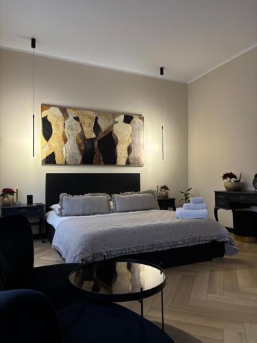 a bedroom with a large bed and a table at Harison Rynek in Bolesławiec