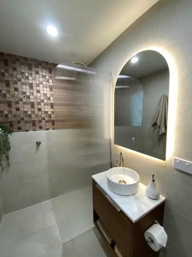 a bathroom with a sink and a shower and a mirror at Copeland House in Copeland
