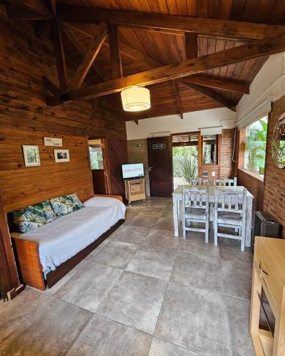 a bedroom with a bed and a table in it at KEIKI Complejo Cabañas in Mar del Plata