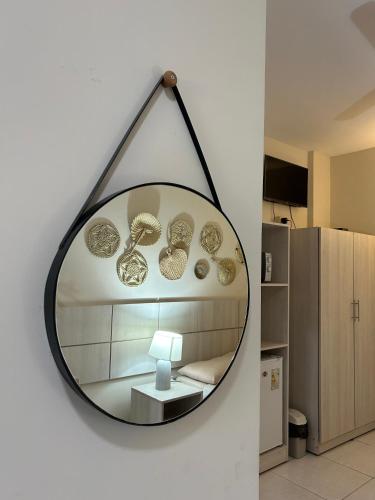 a mirror hanging on a wall in a room at De la Mora Hostal in Fernando de la Mora