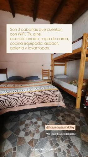 a bedroom with two bunk beds in a room at Hospedaje Espindoliky in Bella Vista