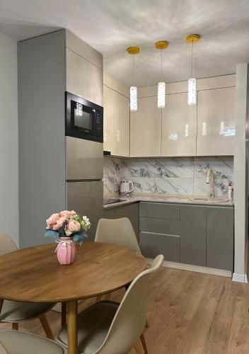 a kitchen and dining room with a table and chairs at Rainbow Residence Batumi in Batumi