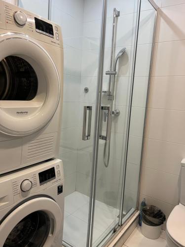 a washing machine and a shower in a bathroom at Seafront place Spinola StJulians in St. Julianʼs