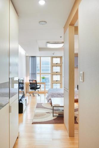 a bedroom with a bed and a desk at Gangnam Opal in Seoul