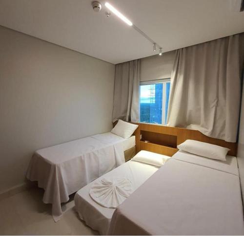 a room with two beds and a window at Salinas Park Resort in Salinópolis