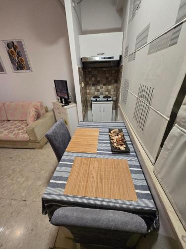 a room with a table and a kitchen with a table sidx sidx sidx at City Center Piazza Studio in Tirana