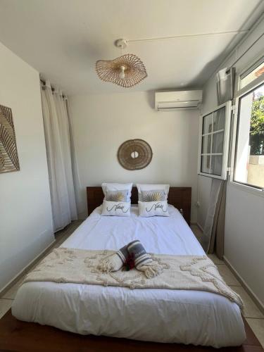 a bedroom with a bed with a blanket on it at Appartement l'écrin in Saint-Claude
