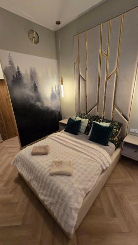 a bedroom with a large bed with towels on it at Delux Apartament z jacuzzi in Pszczyna