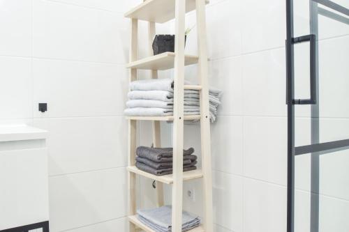 a white towel rack in a bathroom with towels at Olomouc Central Apartment in Olomouc