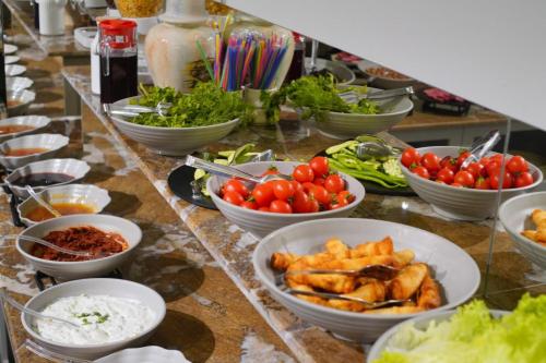 a buffet with bowls of food on a table at newlife suites cappadocia in Nevsehir