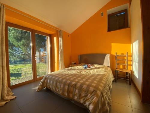 a bedroom with a bed and a large window at Maison familiale in Vars