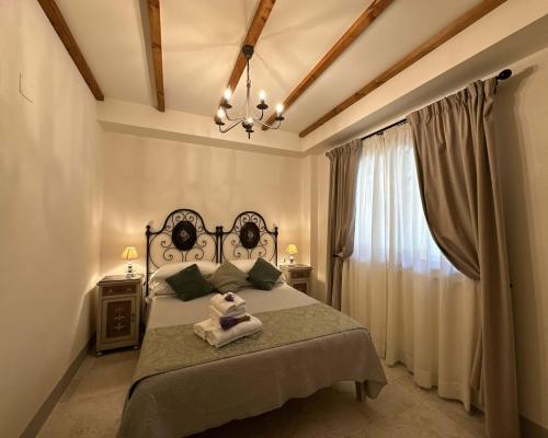 a bedroom with a large bed and a window at Tenuta Fiumara in Marina di Grosseto