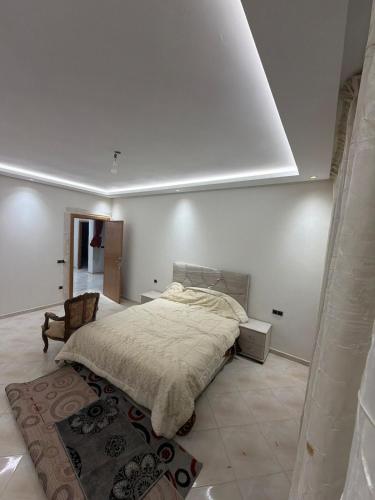 a bedroom with a bed in a white room at Saad's villa in Mohammedia