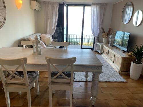 a living room with a wooden table and chairs at Suite Incanto lago di Garda in Torri del Benaco