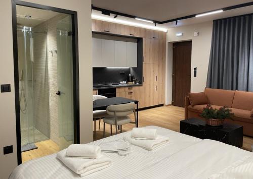 a room with a bed and a kitchen and a living room at Philoxenia by nature in Karkaloú