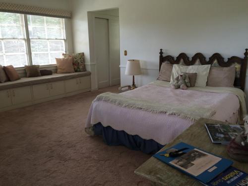 a bedroom with a bed with a teddy bear on it at Elegant suite-30 day minimum in Carmel