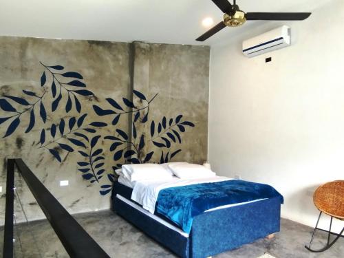 a bedroom with a bed and a wall mural at HELEN HOUSE Bello Horizonte in Santa Marta