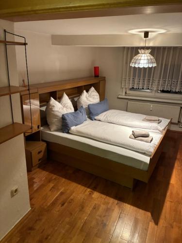 een slaapkamer met een groot bed met blauwe en witte kussens bij Ferienwohnung Flohblick in Floh