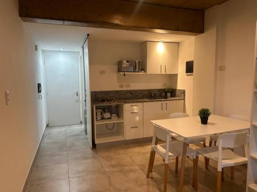 a kitchen and dining room with a table and chairs at Studio 44 Escobar in Belén de Escobar