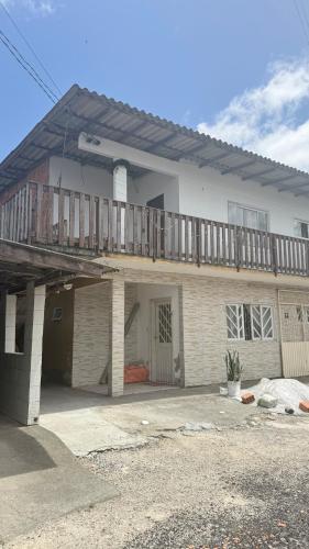 a house with a deck on top of it at Bruna in Florianópolis