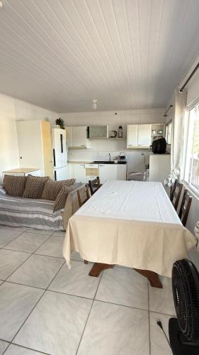 a kitchen with a large white table in a room at Bruna in Florianópolis
