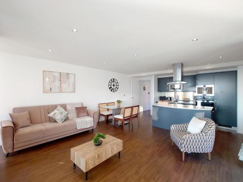 a living room with a couch and a table at Fully Serviced Two Bed Apartment by ExCeL & O2 in London