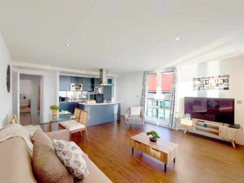 a living room with a couch and a table at Fully Serviced Two Bed Apartment by ExCeL & O2 in London