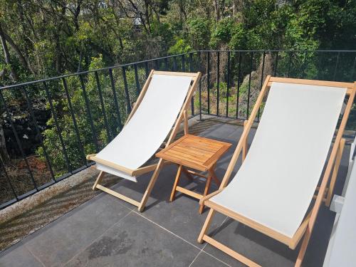 two white canvases on a balcony with a chair at Blue Horizon Apartments in Varadouro