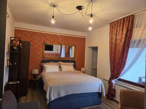 a bedroom with a large bed and a window at Studio Apartman Lipik in Lipik
