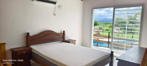 a bedroom with a bed and a large window at DUPLEX Stadium in Tanti