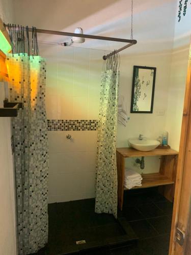 a bathroom with a shower and a sink at El Edén in Guarne