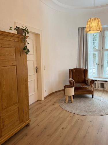 a living room with a chair and a table at Waldquartier Erzgebirge in Thermalbad Wiesenbad