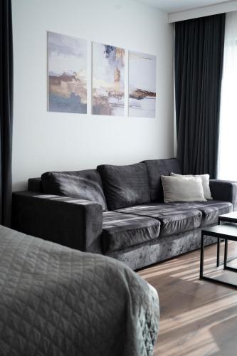 a living room with a couch and a table at Felicita Deluxe Apartments with Free Parking in Sarajevo