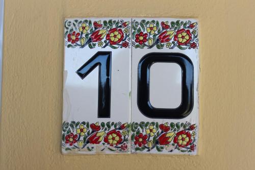 a white plaque with the number on a wall at Villa Medusa in Hersonissos
