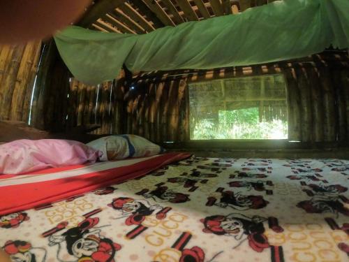 En eller flere senge i et værelse på Sacha Wasi - Jungle Medicine Community
