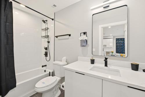 a white bathroom with a sink and a toilet at LUX 1 BD Apartment In Union Market in Washington, D.C.