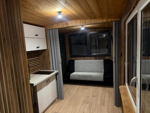 a small room with a bed in a tiny house at Domki pod Kurzą Górą in Kurzętnik