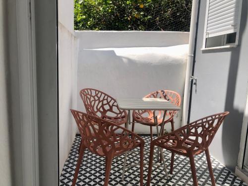 a table and two chairs on a patio at Casa 27 - Sete Rios in Lisbon